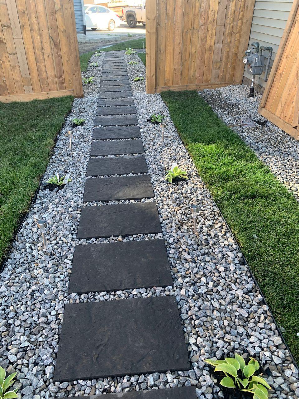 Side yard stepping stone pathway with black slate and white river rock